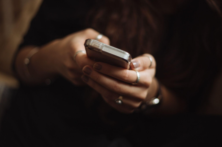 Woman betting using a mobile app